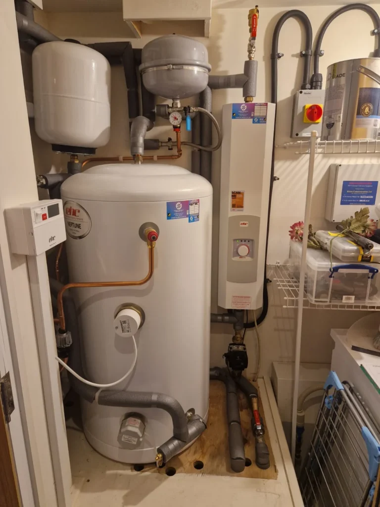 Electric boiler, unvented cylinder and expansion vessel installed in a plant cupboard