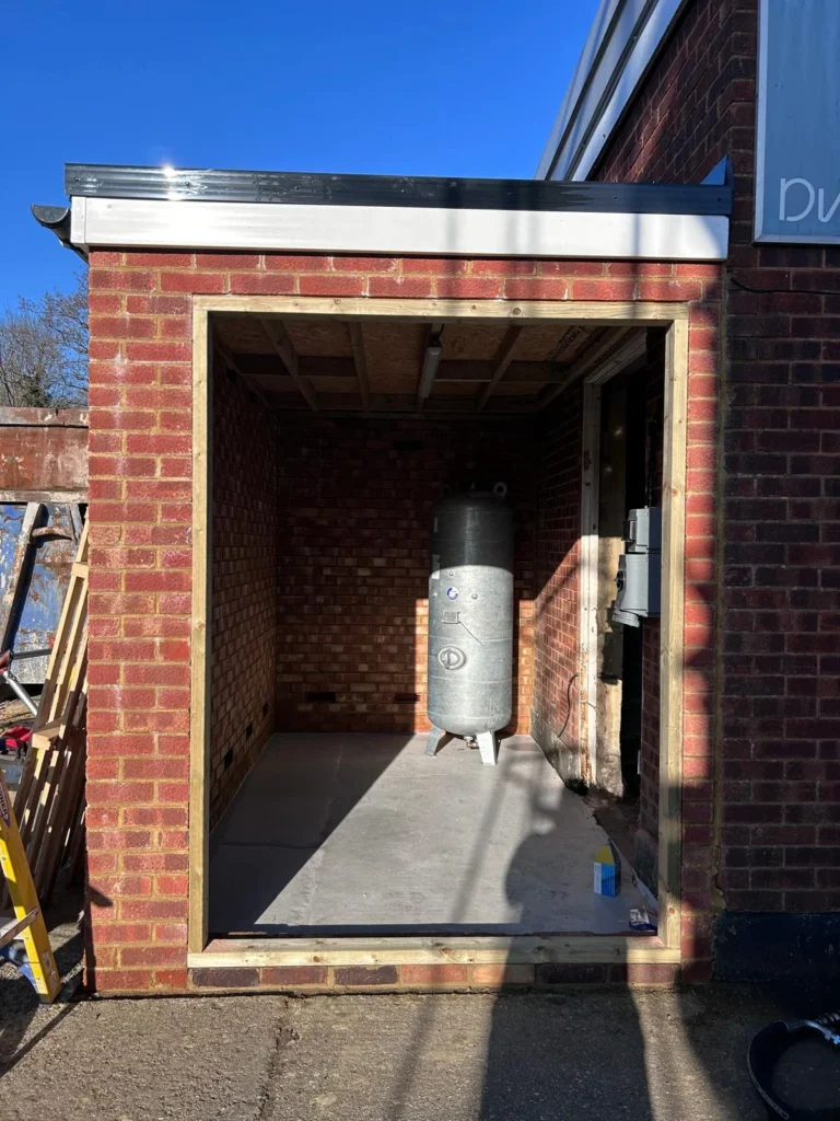 Boiler plant installed inside a brick external boiler house with the doors open