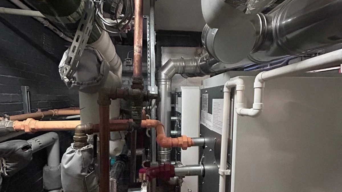 Large bore heating pipework, valves and insulated ductwork in a commercial plant room