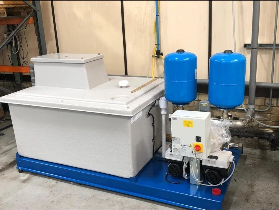 Packaged cold water booster set with a break tank and two pressure vessels on a skid