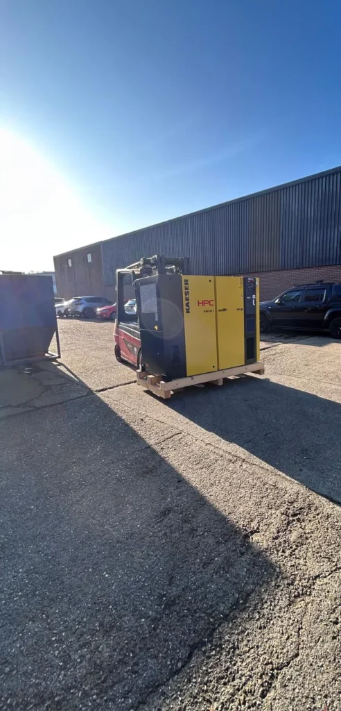 New air compressor, dryer and 500 litre receiver on a pallet outside an industrial unit