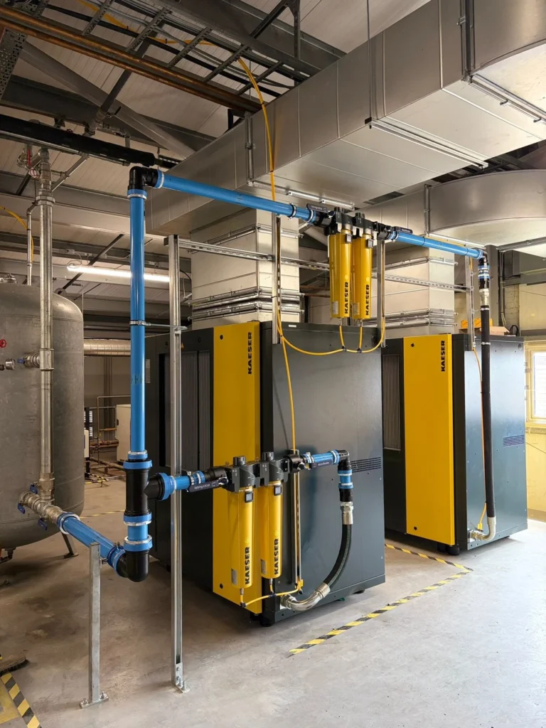 Kaeser compressed air dryers and filtration feeding a blue aluminium ring main in a commercial workshop