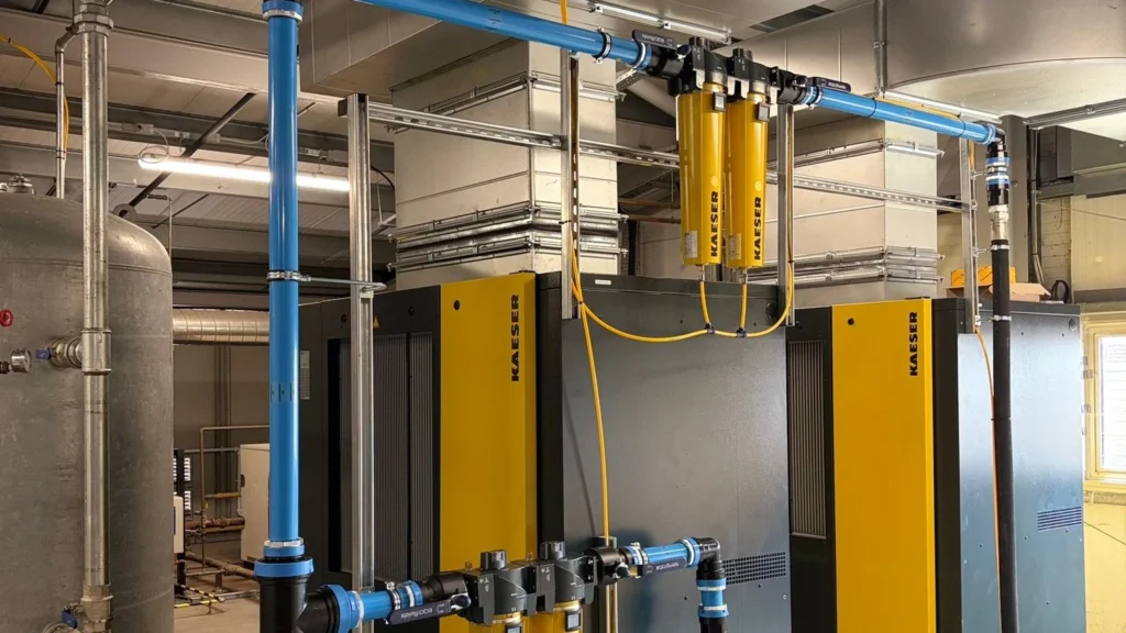 Kaeser compressed air dryers and filtration feeding a blue aluminium ring main in a commercial workshop