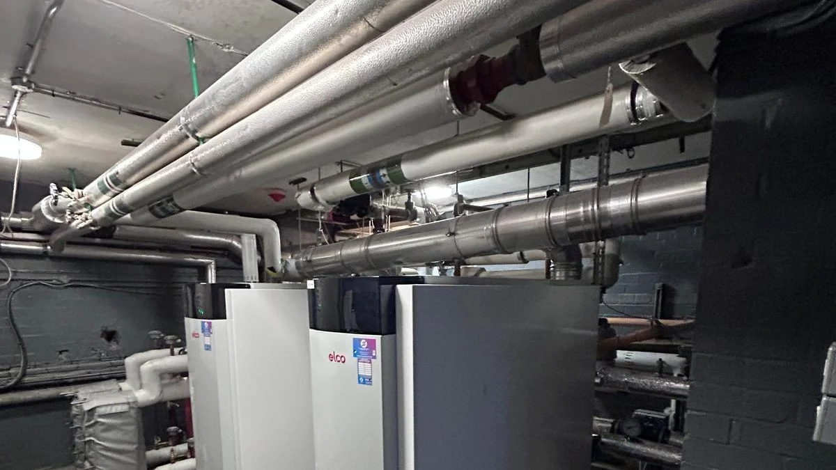 Large bore insulated pipework and boiler plant in a hotel basement plant room