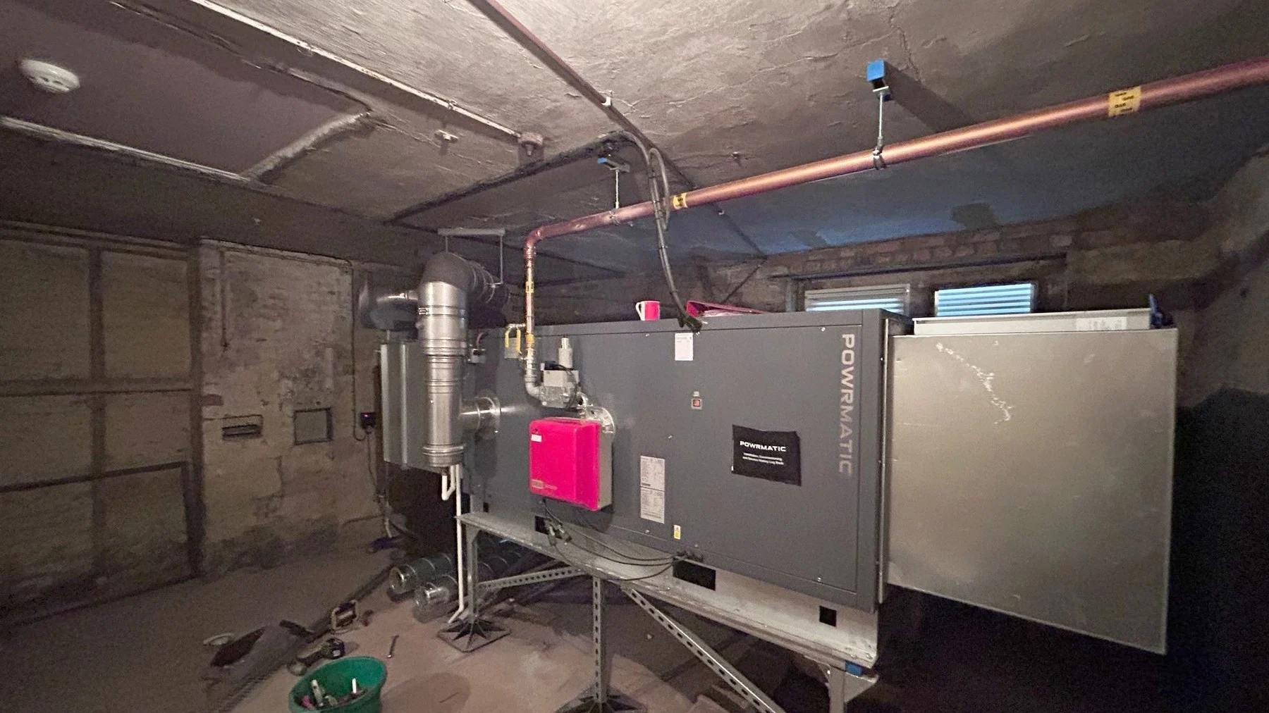 Gas fired air handling unit with burner and control panel installed in a church basement