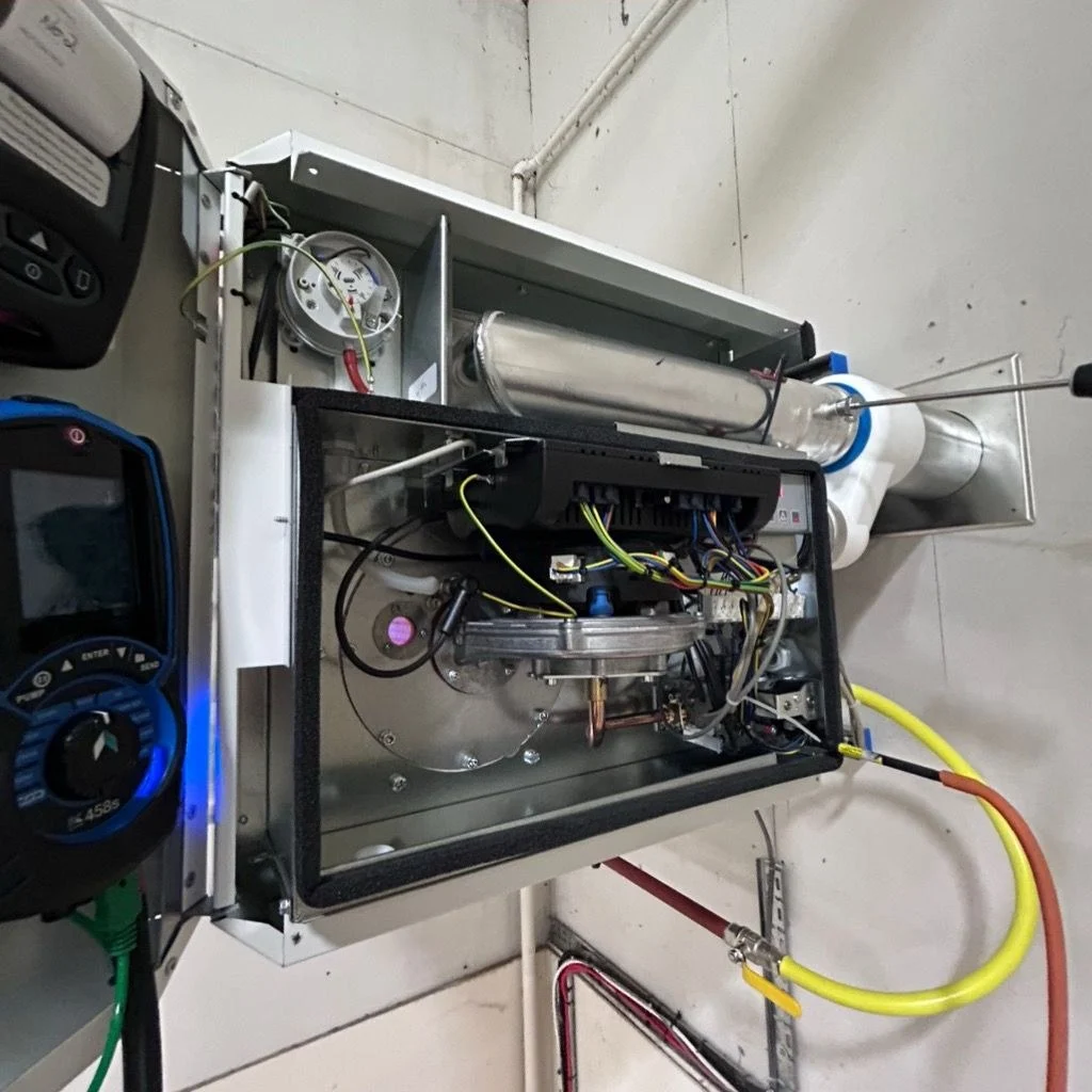 Flue gas analyser connected to a warm air unit heater during commissioning