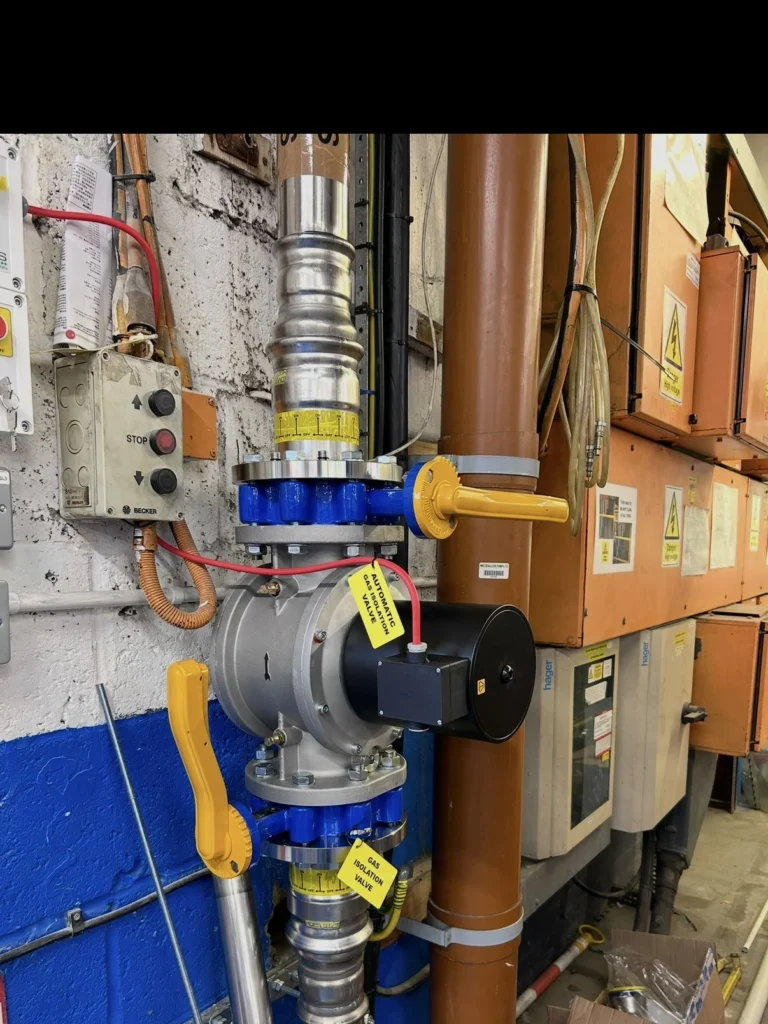 Actuated gas valve and interlock control panel wired into the fire alarm above commercial boiler plant